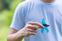 Un uomo tiene in mano un nastro azzurro simbolo della prevenzione dei tumori alla prostata